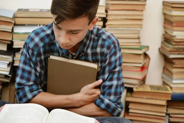 guy in a plaid shirt is studying old books