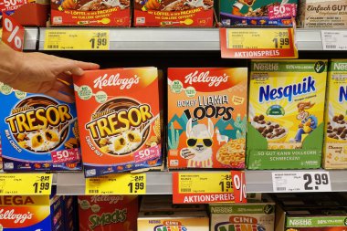 GERMANY - OCTOBER 2018: Shelves with Kellogg's and Nestl brand breakfast products for kids in a German REWE supermarket. clipart