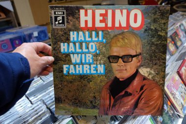 THE NETHERLANDS - SEPTEMBER 2020: Album: Heino - Halli, Hallo, wir fahren, 1970 released LP record of the  German singer of Schlager and traditional Volksmusik Heino in a second hand store. clipart
