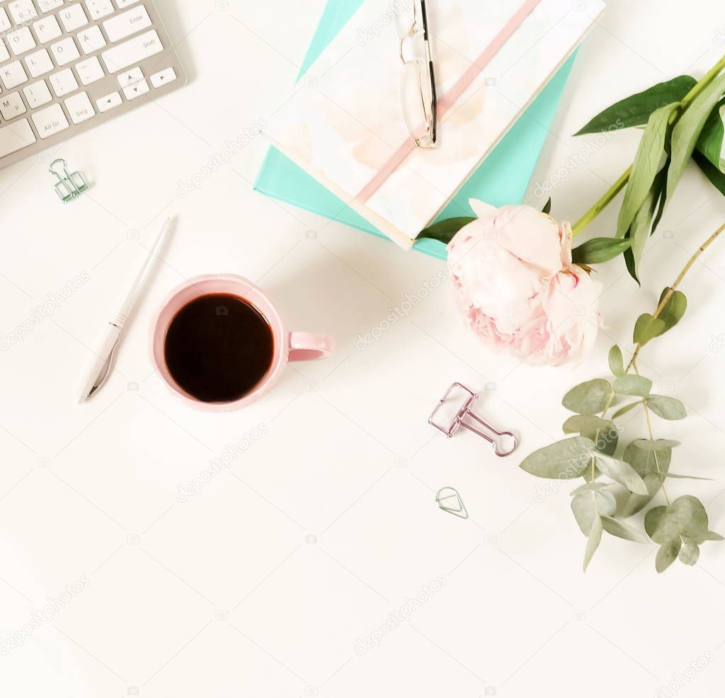 Flat lay women's office desk. Female workspace with laptop,  flowers peonies,  accessories, notebook, glasses, cup of coffee on white background. Top view feminine background.Copy space