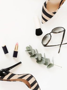 Düz yatıyordu, en iyi kadın moda aksesuarları görünümünü. Bej çanta, güneş gözlüğü, yüksek topuk ayakkabı ve beyaz arka plan üzerinde kozmetik. Kopya alanı