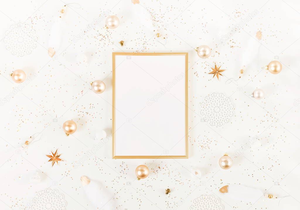 Christmas background from gold and white Christmas decorations and frame mock up  . Xmas composition of New Year's Christmas balls. Winter holiday concept.Flat lay. Top view. Copy space