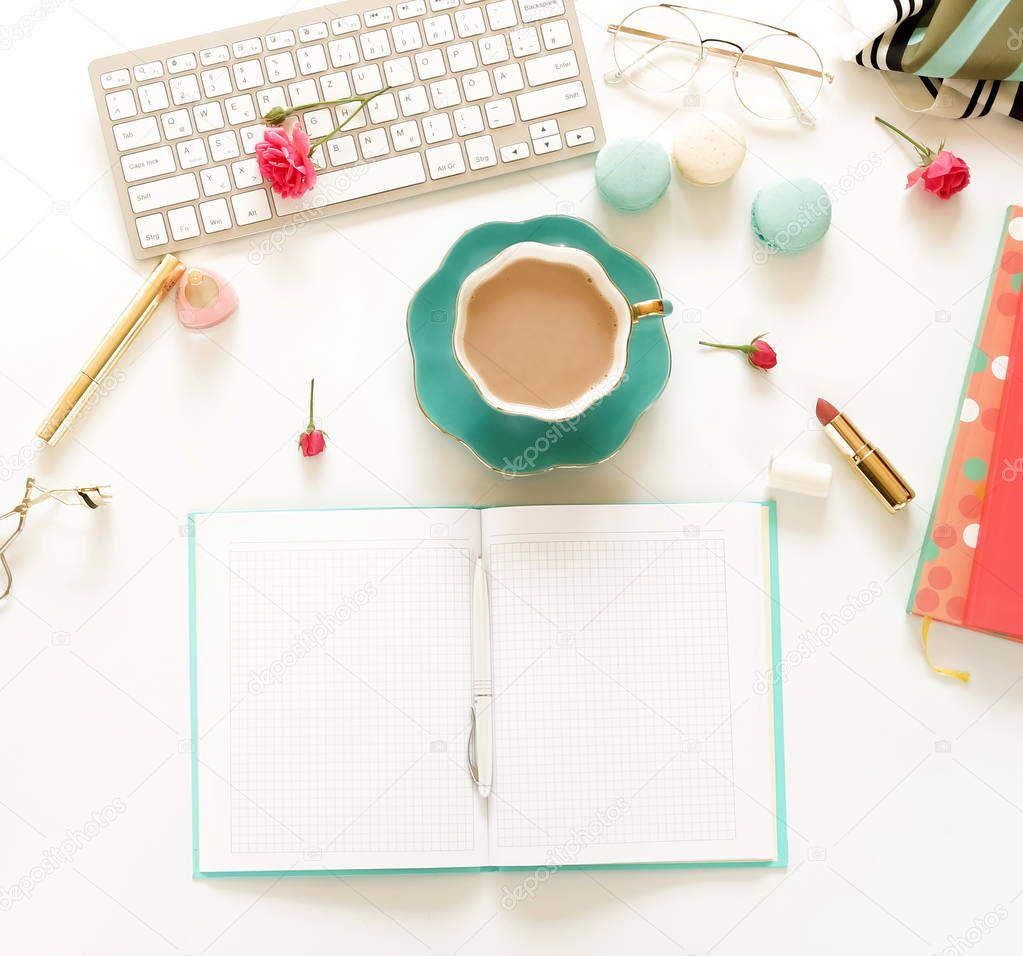 Flat lay women's office desk. Female workspace with laptop,  flowers roses,  accessories, open notebook mock up, glasses, cup of coffee, cosmetics on white background. Top view .Copy space. 