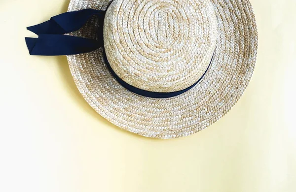 top view of straw hat on yellow background