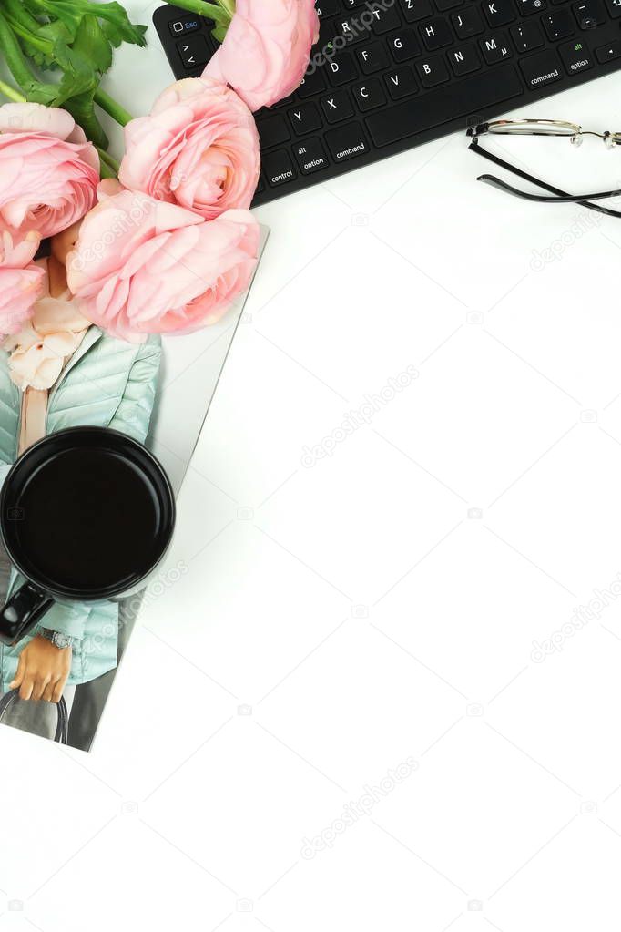 flat lay with workspace with keyboard, ranunculus flowers and cup of coffee