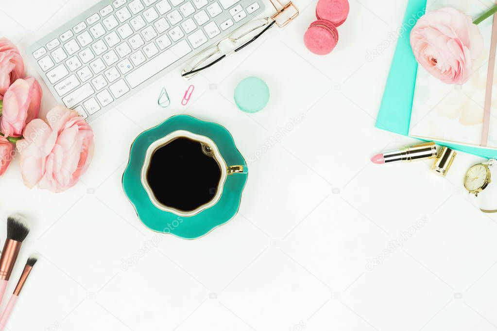 top view of female workspace with keyboard, ranunculus flowers and cup of coffee