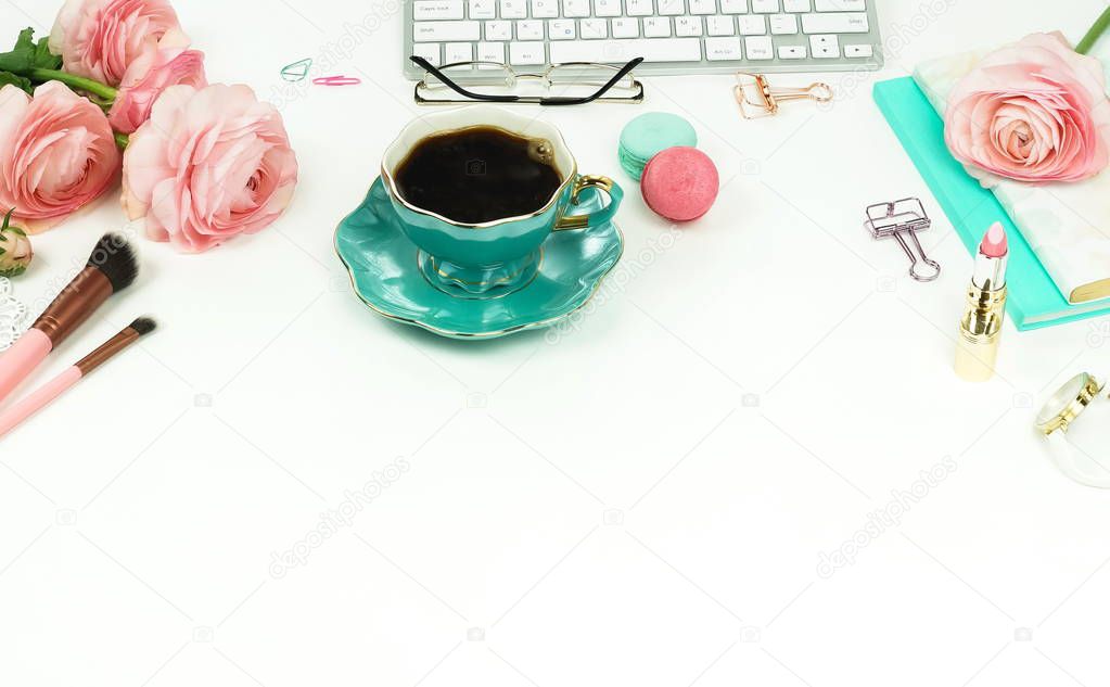 close up view of female workspace with keyboard, ranunculus flowers and cup of coffee