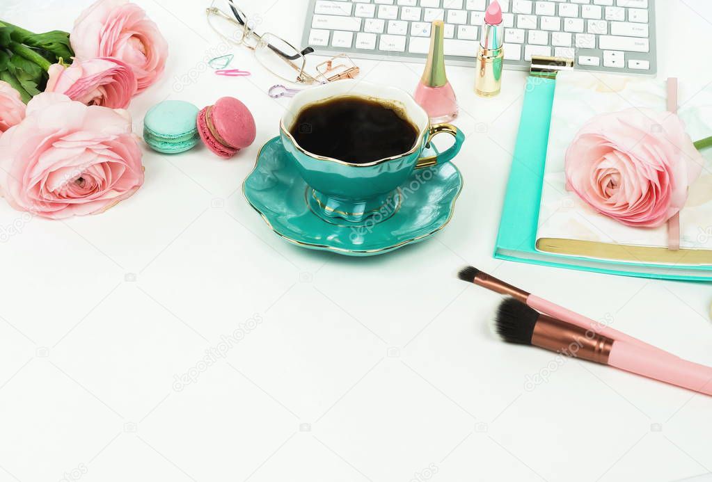 close up view of female workspace with keyboard, ranunculus flowers and cup of coffee