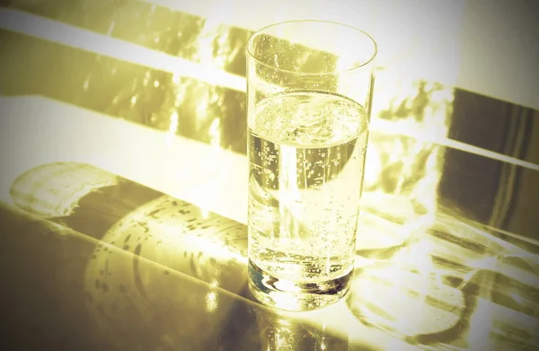 close up view of glass of water on light background