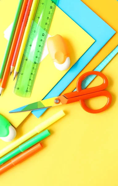 Back to school background. School supplies bright colors at abstract colored background. Education concept. Top view. Copy space