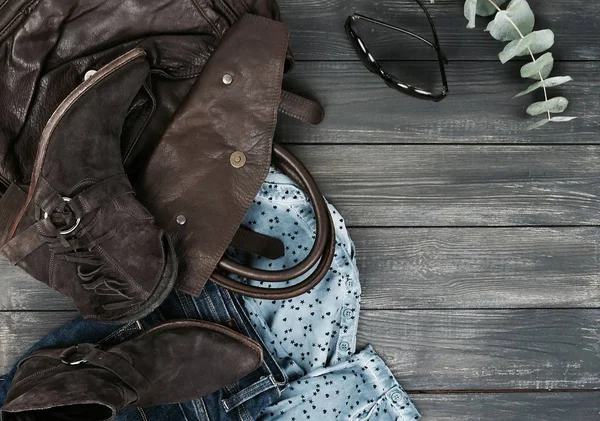 feminine stylish outfit on wooden background