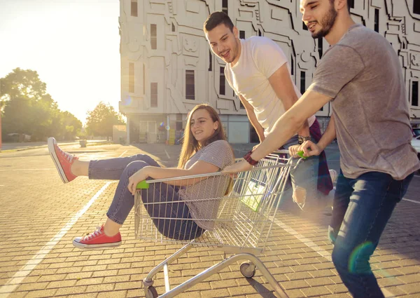 Photo Two Guys Pushing Girl Shopping Trolley — Stock Photo, Image
