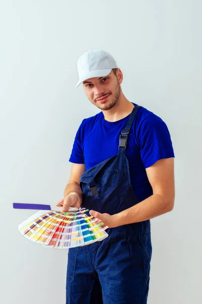 Uniform Guy Hat Standing White Background While Choosing Colour — Stock Photo, Image