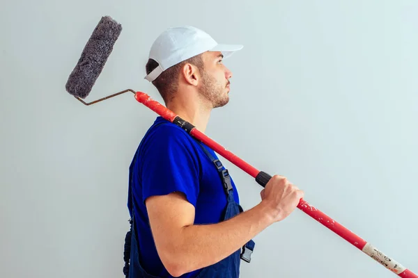 Side View Guy Blue Uniform While Hold Paint Roller White — Stock Photo, Image