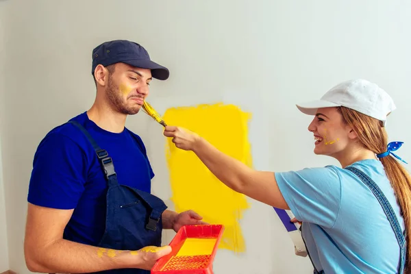 Sweet married couple relaxing while painting their new house
