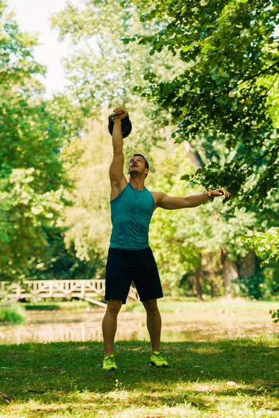 Izmos Férfi Csinál Edzés Kettlebell Természetben — Stock Fotó