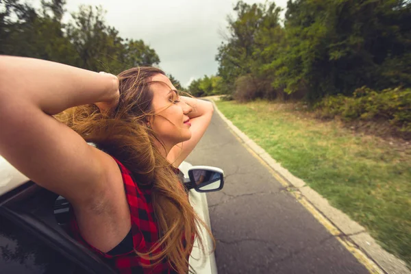 Una Chica Está Con Cabeza Fuera Ventana Coche Mientras Conduce — Foto de Stock