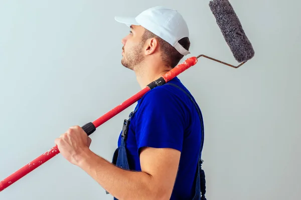 Guy Blue Uniform Hold Paint Roller White Wall — Stock Photo, Image