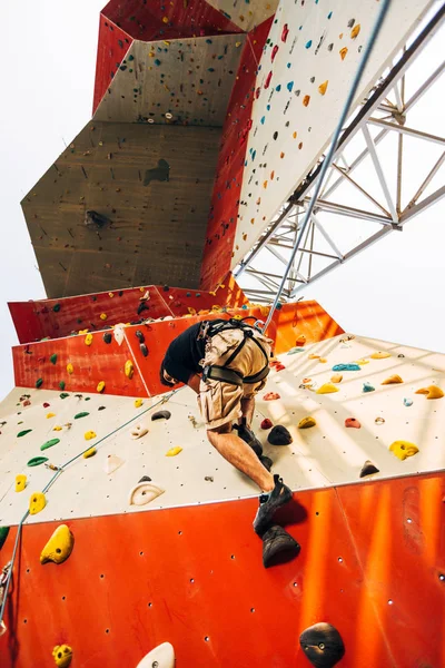 Człowiek Wspinaczka Sztucznej Ścianie Wspinaczkowej Siłowni Bouldering — Zdjęcie stockowe