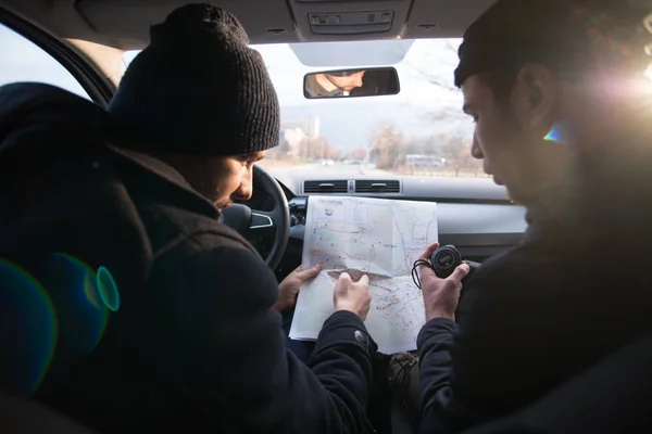 Bank robbers,planning their next hit while holding a gun and counting on a stop watch the time they need to get from one point on the map to another one.