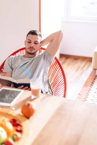 Jovem forte saudável lendo um livro no início da manhã whi — Fotografia de Stock