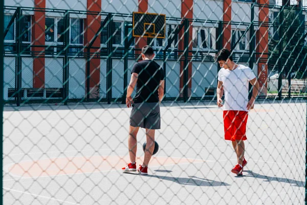 Dos fuertes jugadores de baloncesto jugando pelota en una ciudad urbana baske —  Fotos de Stock