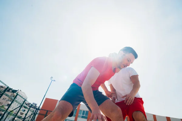 Close up portrait of two basketball players while the push each — Stock Photo, Image