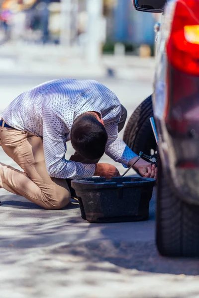 En stark affärsman böjer knät medan han försöker ändra sig. — Stockfoto