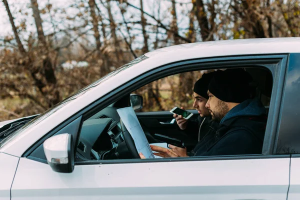 Två beväpnade banditer sitter i en bil och planerar sitt nästa rån., — Stockfoto