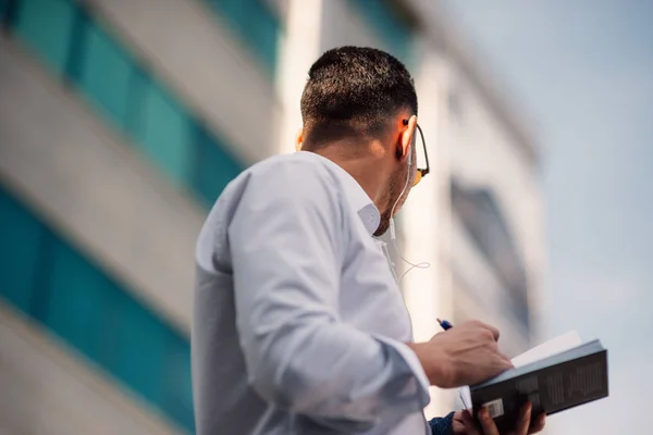 Un hombre de negocios seguro está en el vecindario urbano con su auricular —  Fotos de Stock