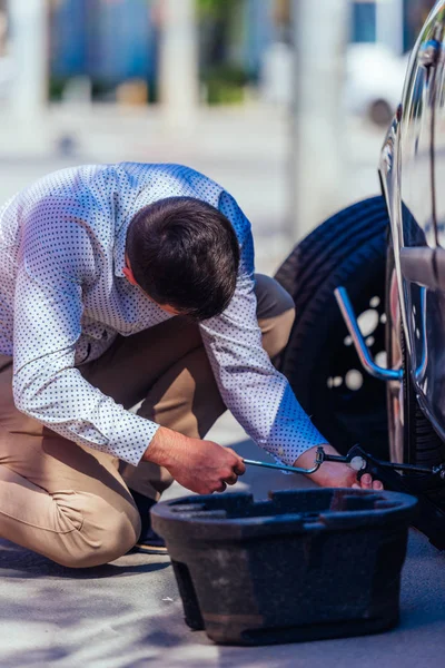 Een sterke zakenman buigt zijn knie terwijl hij probeert te veranderen. — Stockfoto