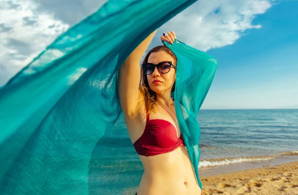 Caucasian woman with blue scarf enjoying freedom on the beach — Stock Photo, Image