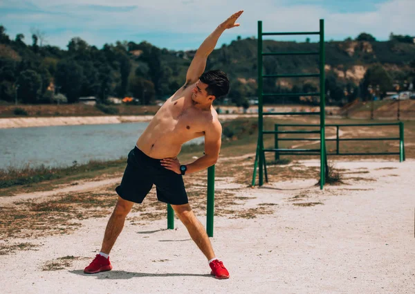Junger stolzer Mann ohne Hemd, der ein sehr hartes Training hat — Stockfoto