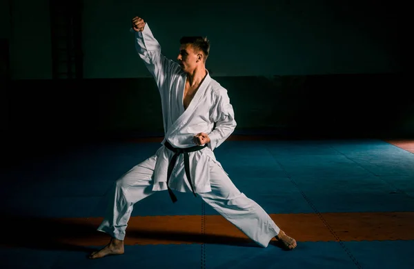 Young man is practicing martial arts in sport gym — Stock Photo, Image