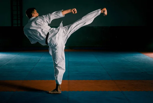 Un kata de karate entrenando al hombre aislado sobre fondo oscuro — Foto de Stock