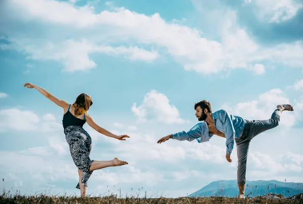 Acrobat pose of a two talented, young dancers at the mountain — ストック写真