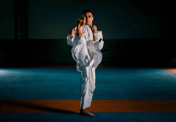 Young black belt fighter training karate in gym — Stock Photo, Image