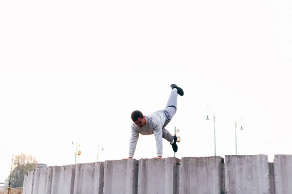 Sportsman jumping over obstacles while exercising parkour tricks — Stock Photo, Image