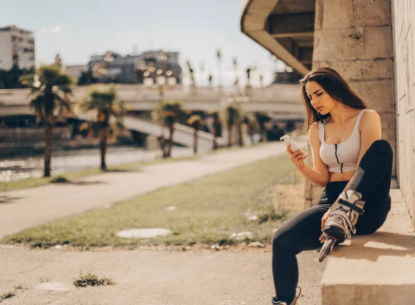 Cute Girl Roller Skates Sitting City Looking Her Phone — Stockfoto