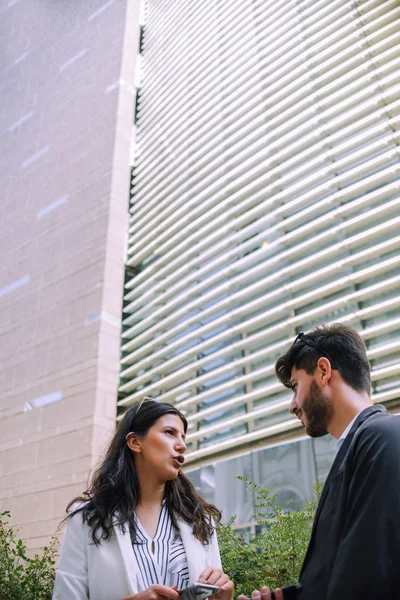 Businessman and businesswoman in front of their workplace — Stock Photo, Image