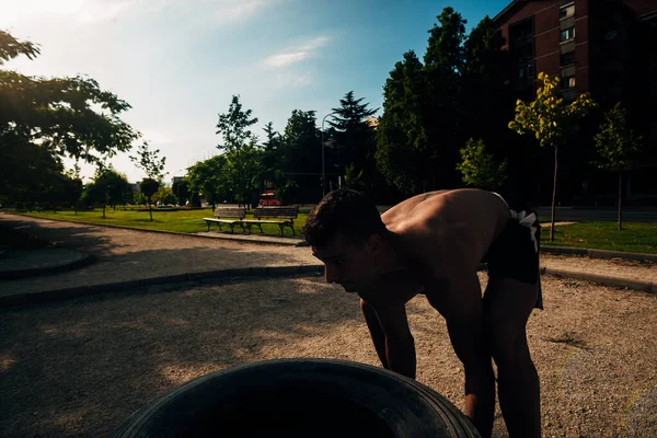 Strong Young Man Athlete Standing Looking Huge Tire Outdoors Gym — ストック写真