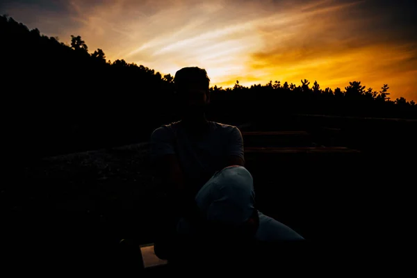Relaxed African American Young Man Sitting Waiting Bench Sunset Sky — ストック写真