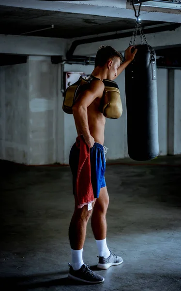 Man showing off his muscular physique. Photo of man with perfect body after training