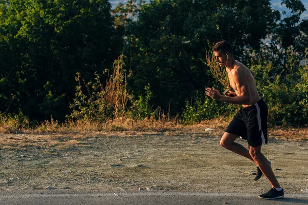 Knappe jogger aan het trainen voor marathon buiten in de zomer — Stockfoto