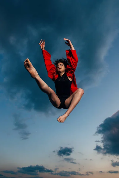 Ugrás a kék felhős ég játékos nő — Stock Fotó