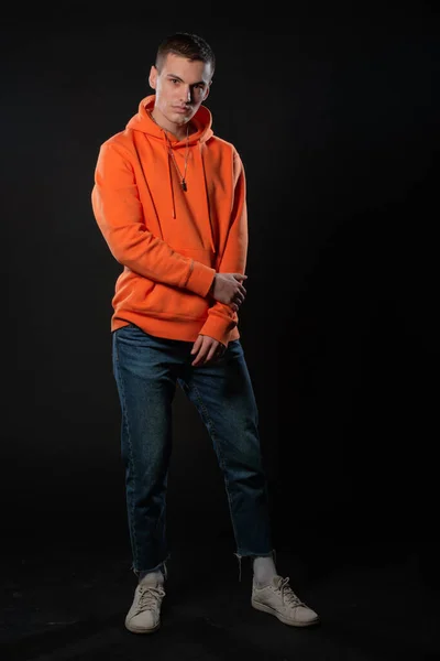 Fiatal Jóképű Férfi Farmer Narancssárga Kapucnis Pózol Miközben Áll Fekete — Stock Fotó