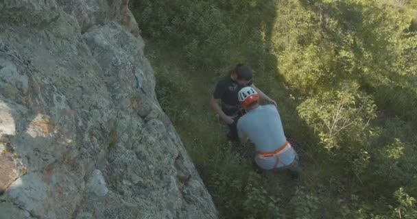 Mężczyzna Przygotowuje Dziewczynę Wspinaczki Skałach Zabezpieczając Jej Liny — Wideo stockowe