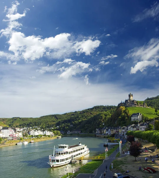 Blue sky and white clouds above imperial castle (Reichsburg) on the Mosel river. Germany, Cochem city