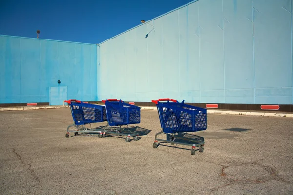 Food carts abandoned in a supermarket Parking lot, economic crisis.