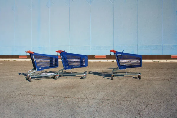 Food carts abandoned in a supermarket Parking lot, economic crisis.